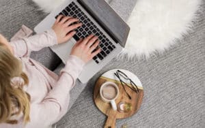 female writing code on laptop